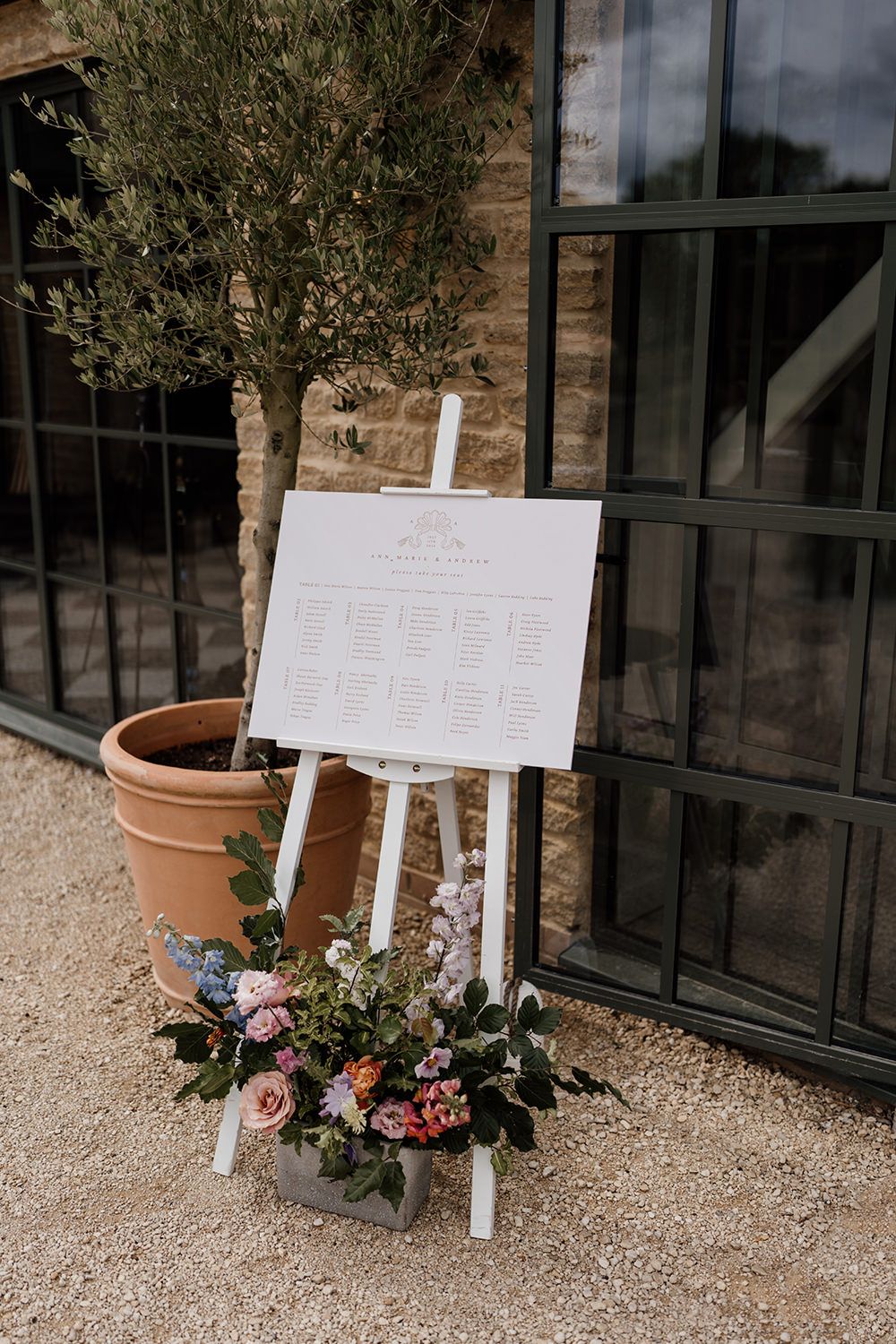 Table sign decorated with bright statement flowers.