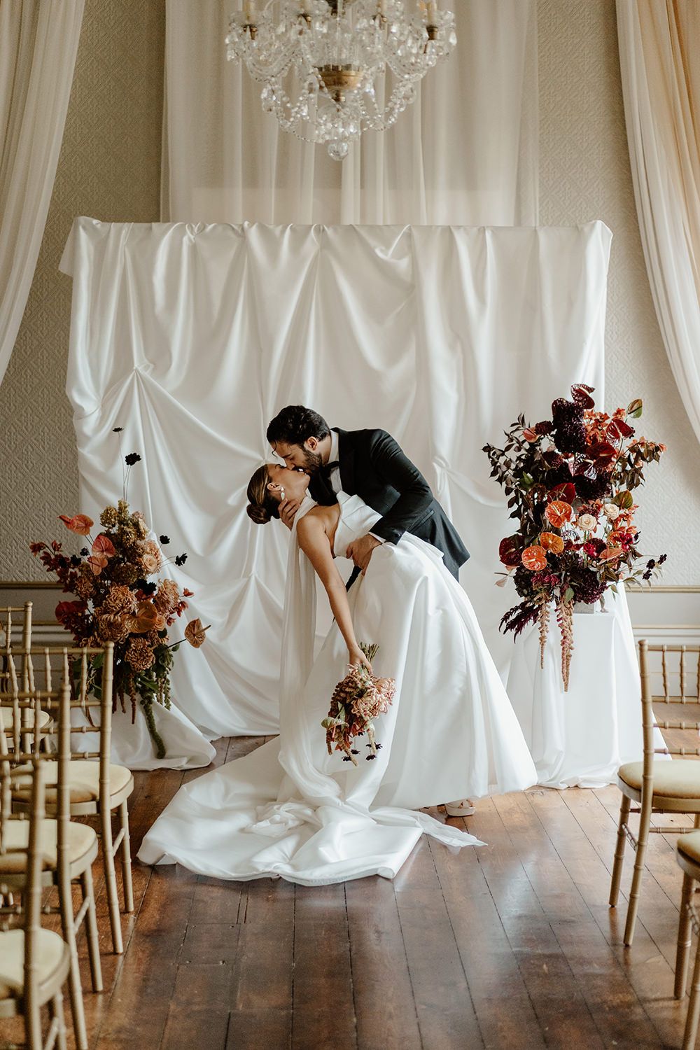 Bride and groom have a dip kiss after their wedding ceremony at Rise Hall.