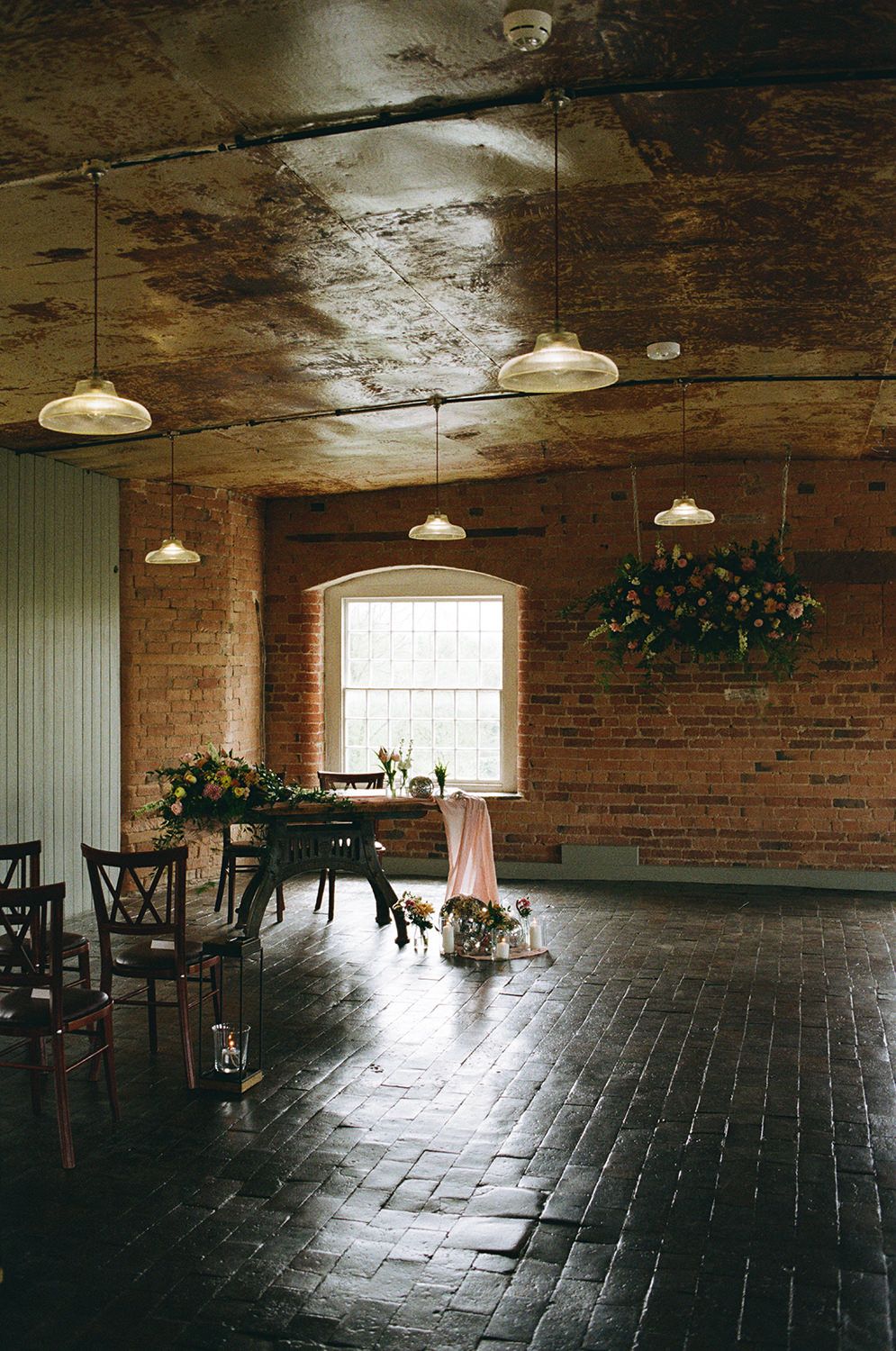 The West Mill ceremony room styled with pastel wild flowers and disco balls.
