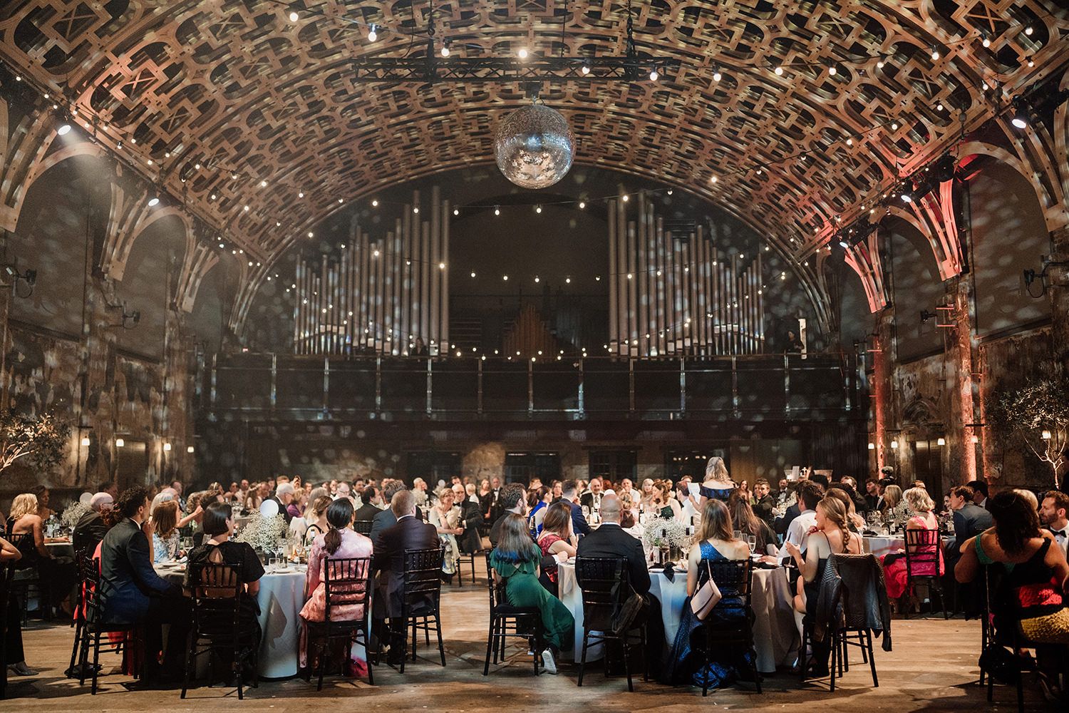 Guests sat listening to wedding speeches at Battersea Arts Centre.