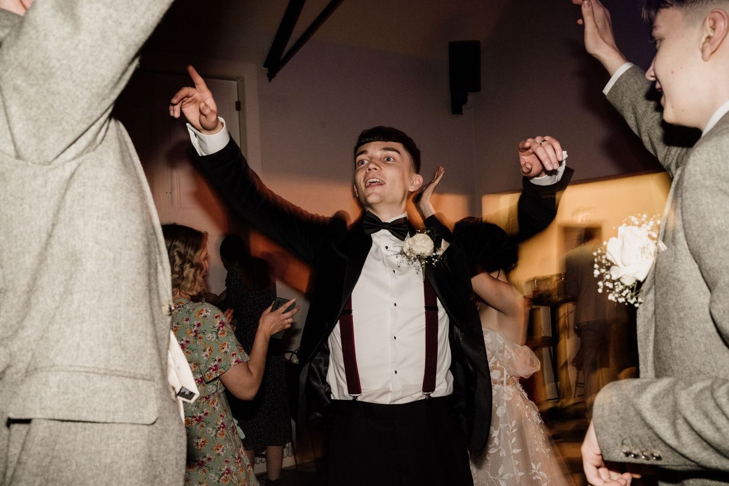 Bridesmaid dancing with friends at wedding party at Bourton Hall.