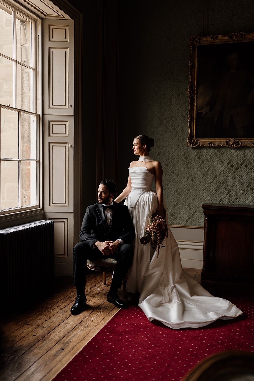 Editorial wedding portrait session: Bride and groom holding hands while looking towards each other.