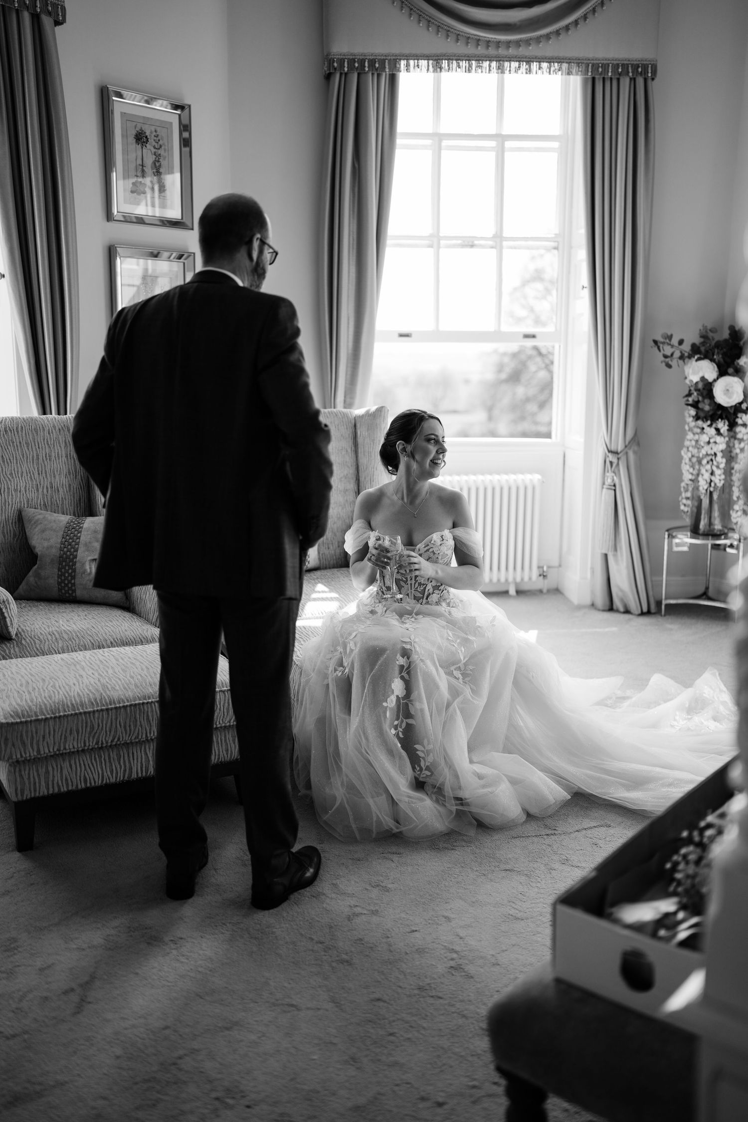 Father talking to her daughter on her wedding morning in black and white.