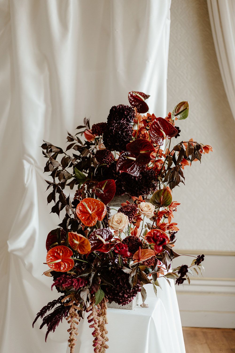 Autumnal wedding flowers with red, burgundy, pink and white flowers.