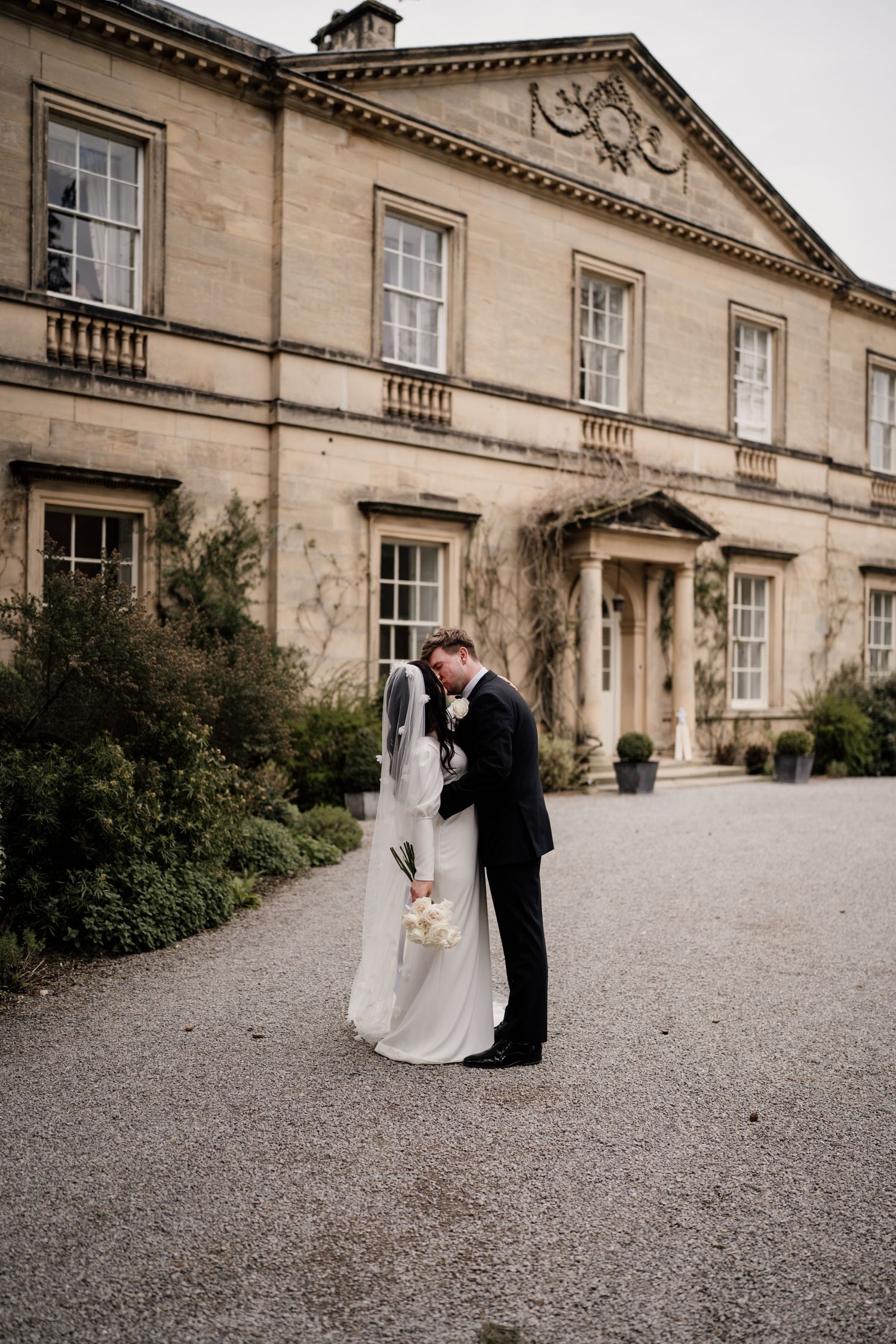Bride and groom couple portraits with the main house at Middleton Lodge Estate behind.