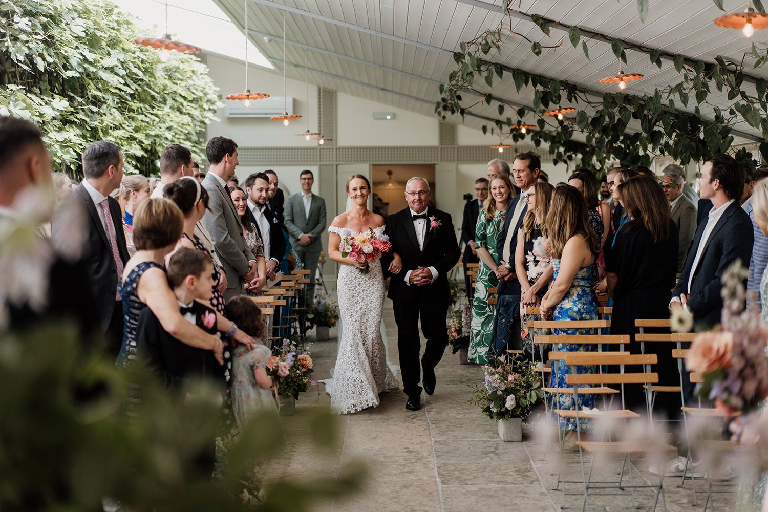 Bride and father of the bride walking down the aisle to the wedding ceremony.