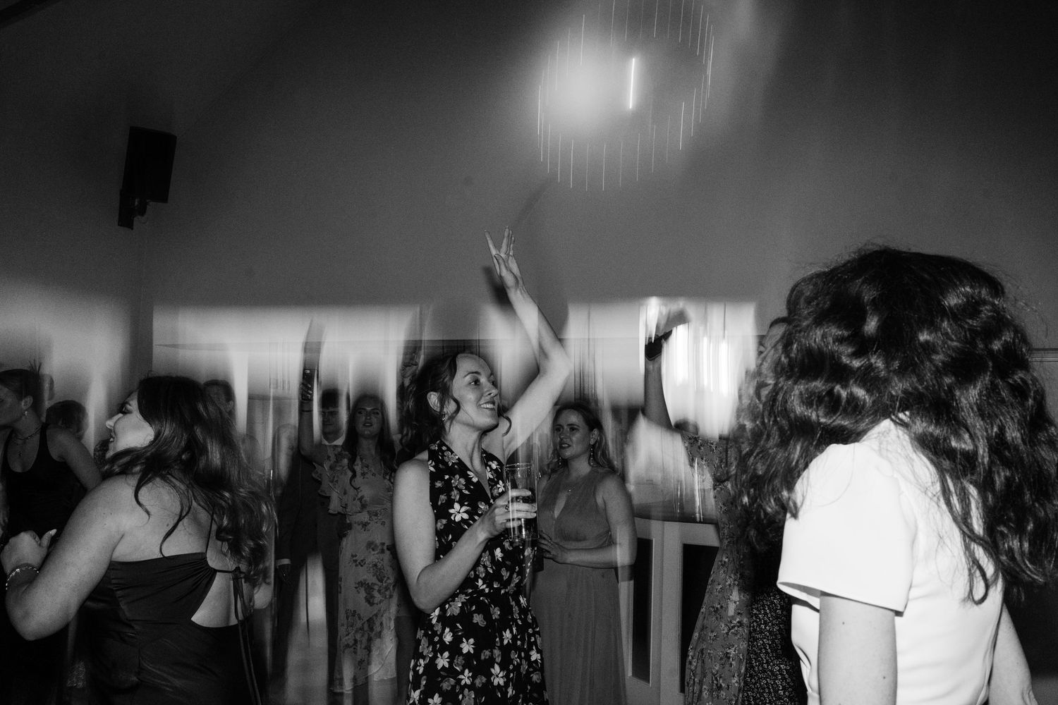 Bridesmaid dancing with friends at wedding party.