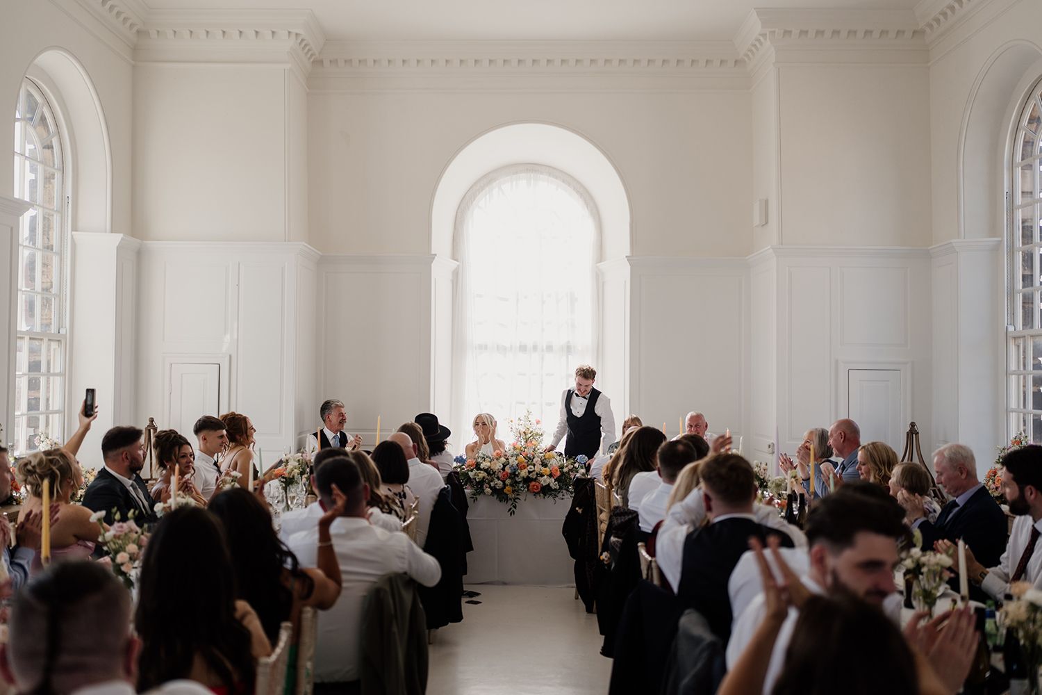 Cheers to love: Guests toasting at a wedding at The Secret Tower Newcastle.