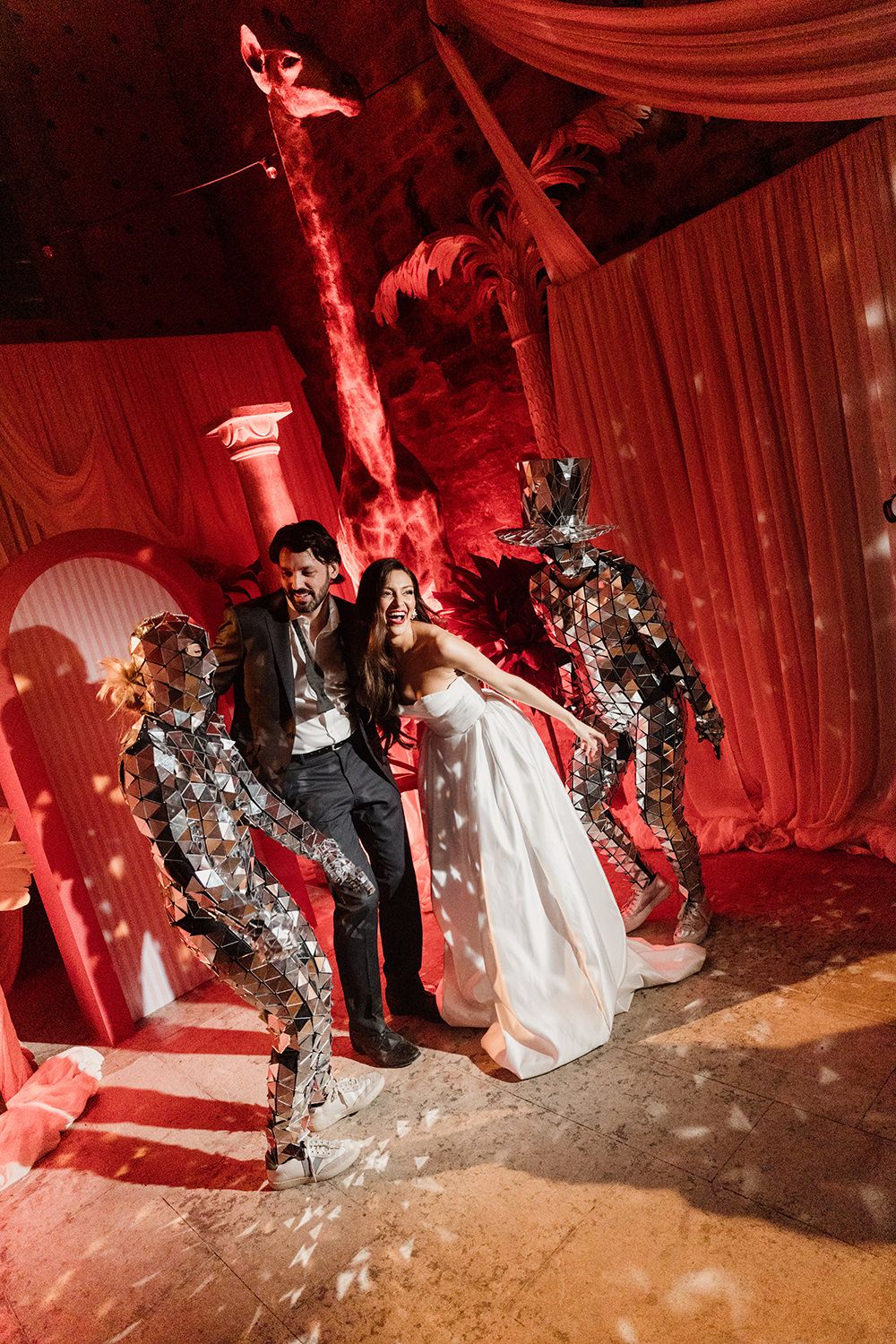 A dramatic wedding party photo sequence with red lighting showing the wedding couple with costumed robots.