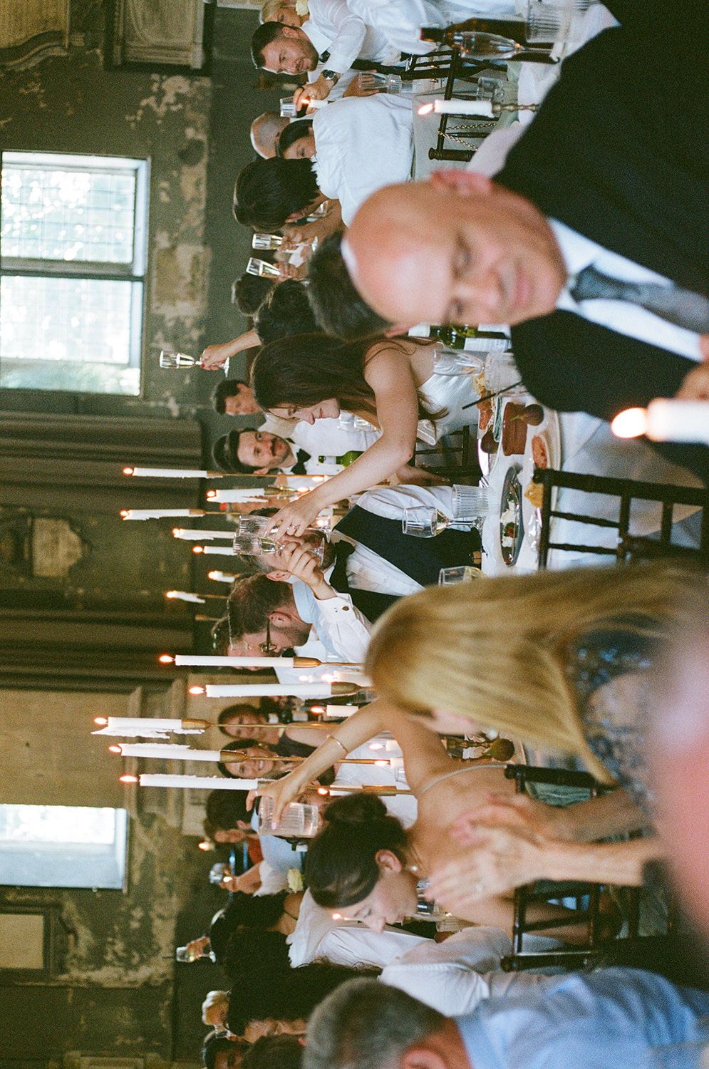 Blurry crowd of people in a dimly lit indoor space with motion blur effects creating an atmospheric party scene.