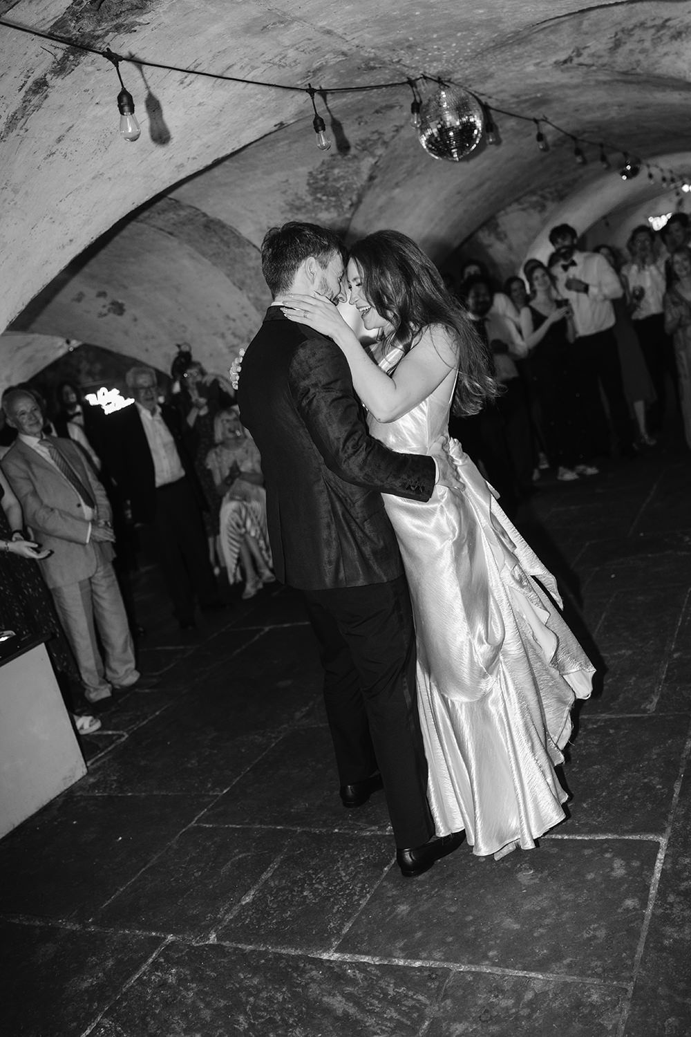 Black and white photos of couples dancing at a lively wedding reception.