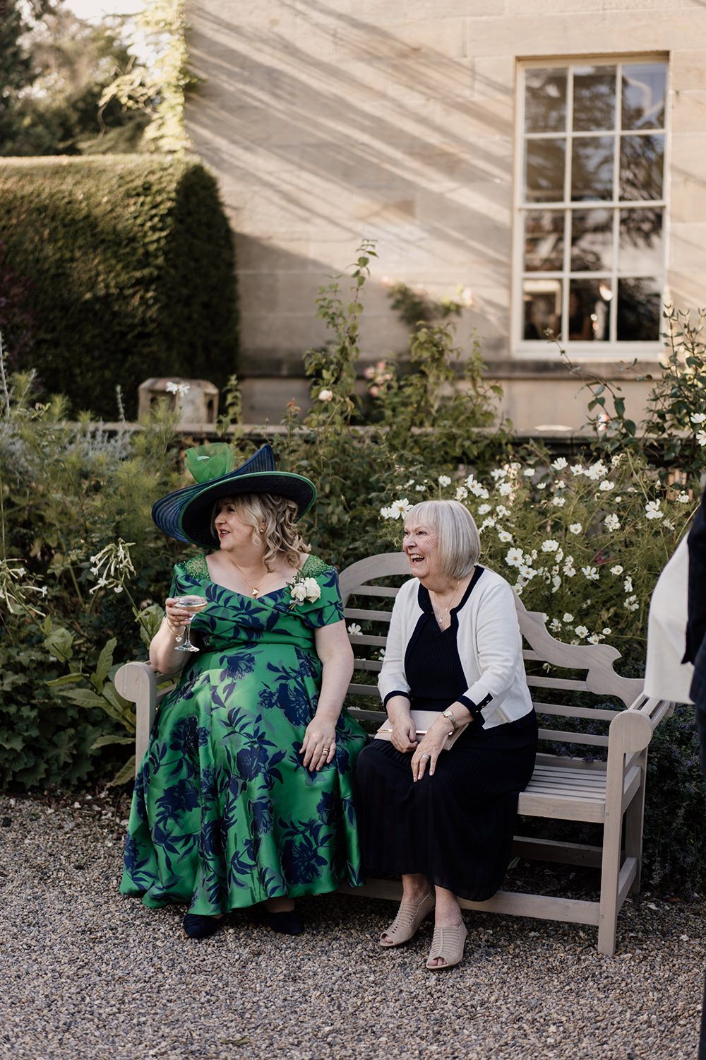 Candid wedding photography: guests enjoying cocktails on the lawn of this luxury UK wedding venue.