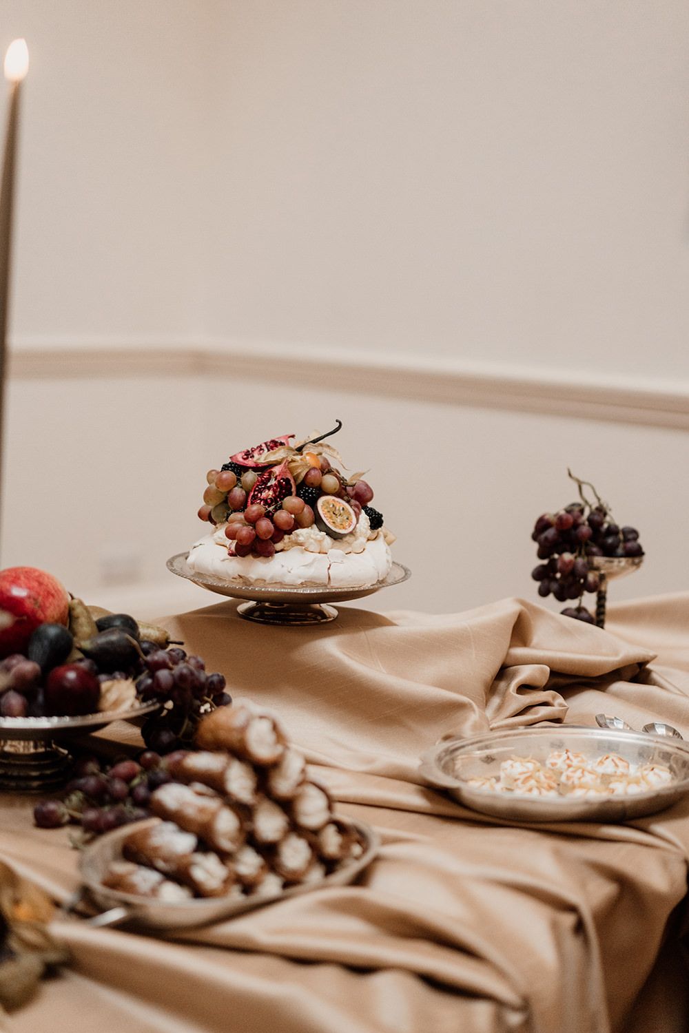 Extravagant dessert table filled with cakes, pastries and candles in the dining room at Rise Hall.