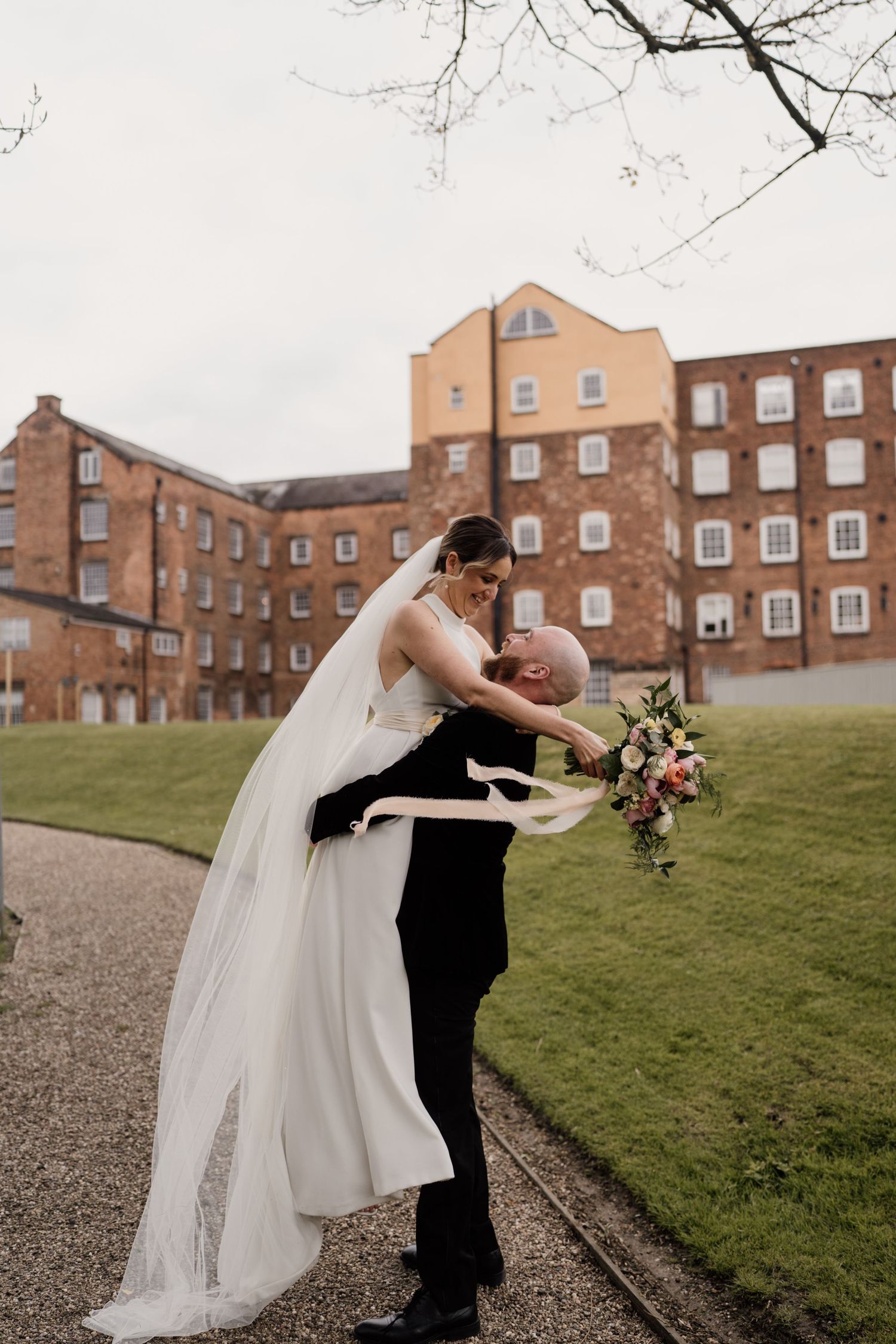 A romantic dance moment captured outside historic brick buildings.