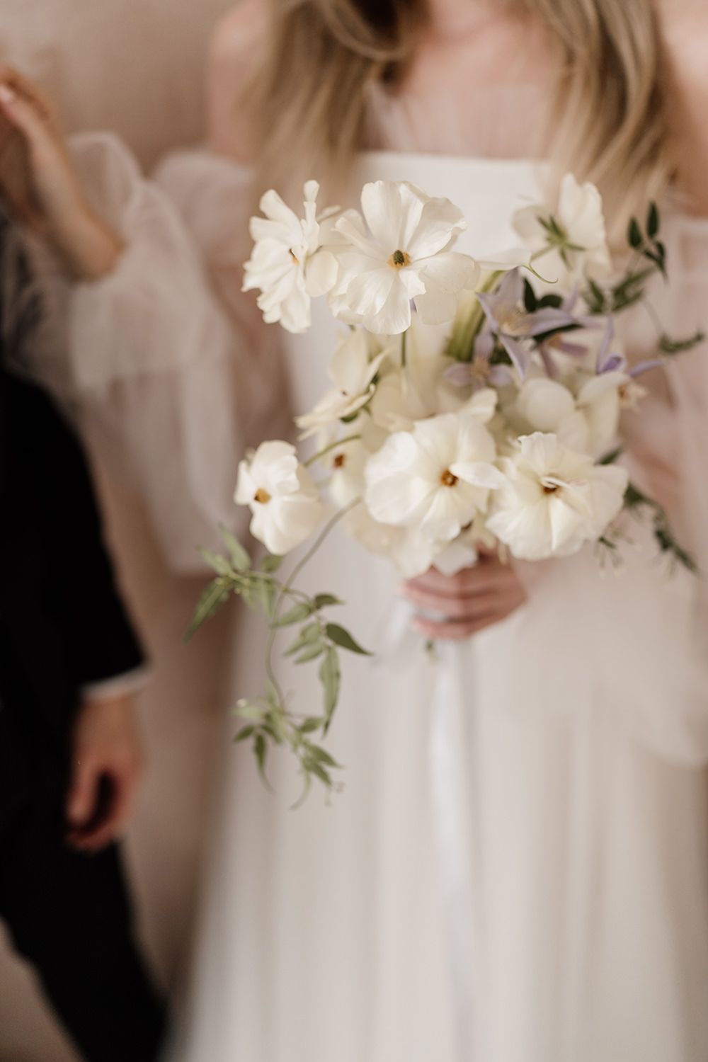 Bride holding white bouquet at wedding in Mallorca.