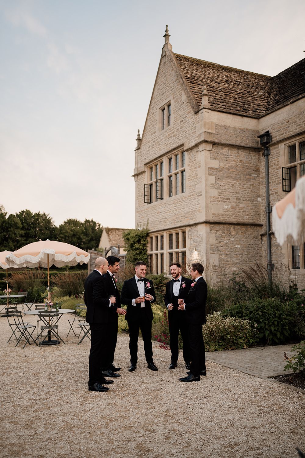 Groom and groomsmen enjoying evening drinks on the terrace at Kin House.