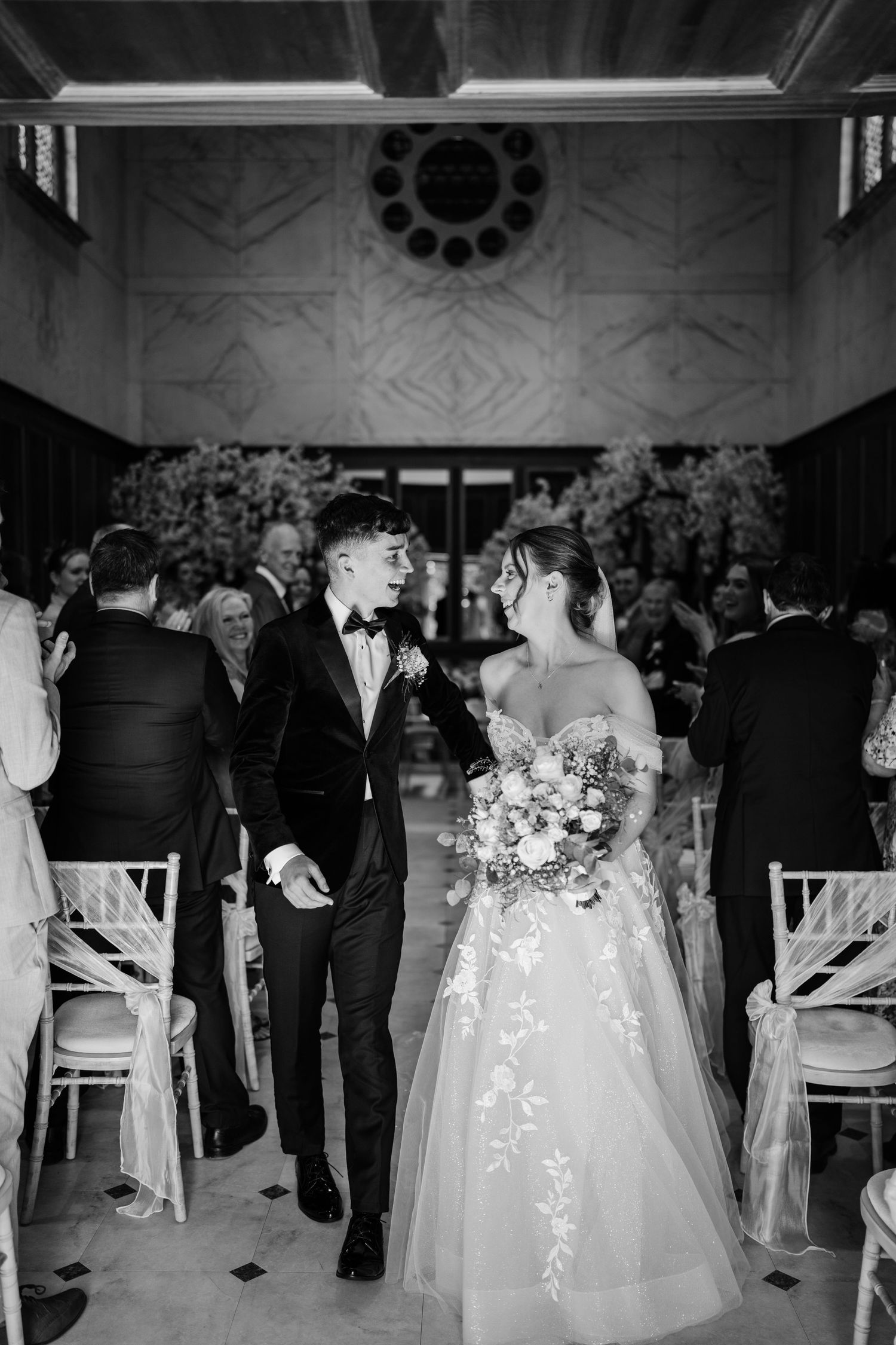 Bride and groom leaving their wedding ceremony at Bourton Hall.