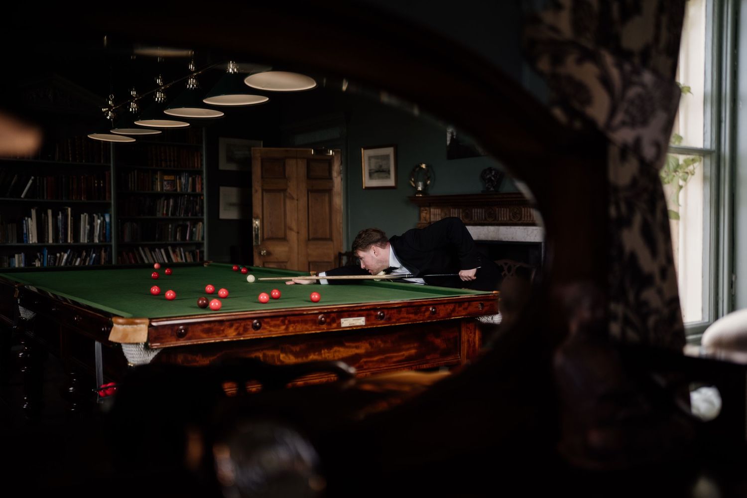 Groomsmen playing pool on the morning of the wedding day.