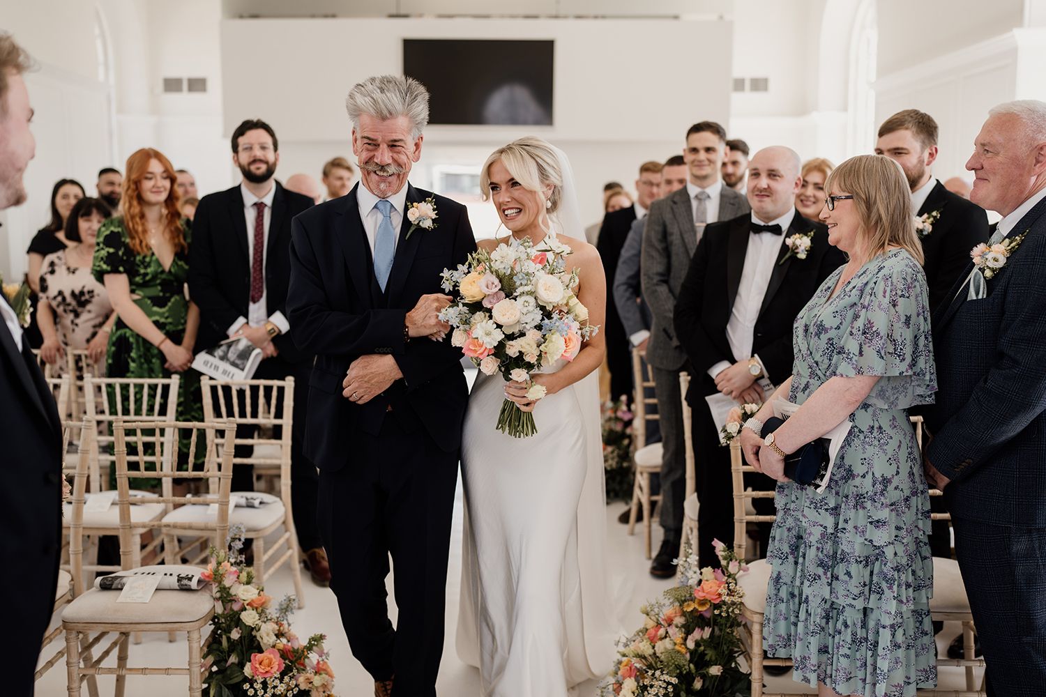 Father of bride and bride walking into wedding ceremony at The Secret Tower.