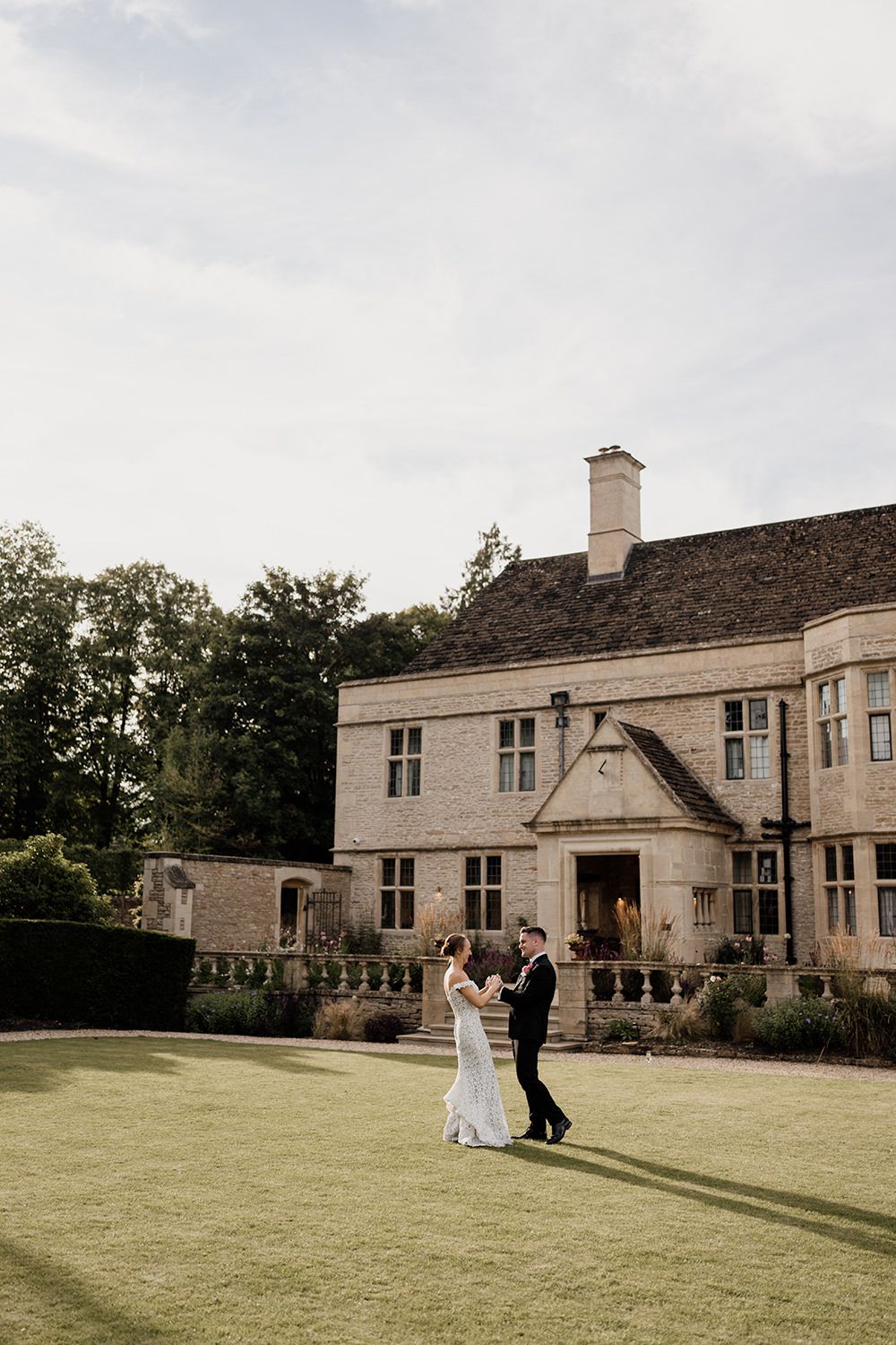 Wedding couple walking through Kin House’s walled gardens during golden hour.