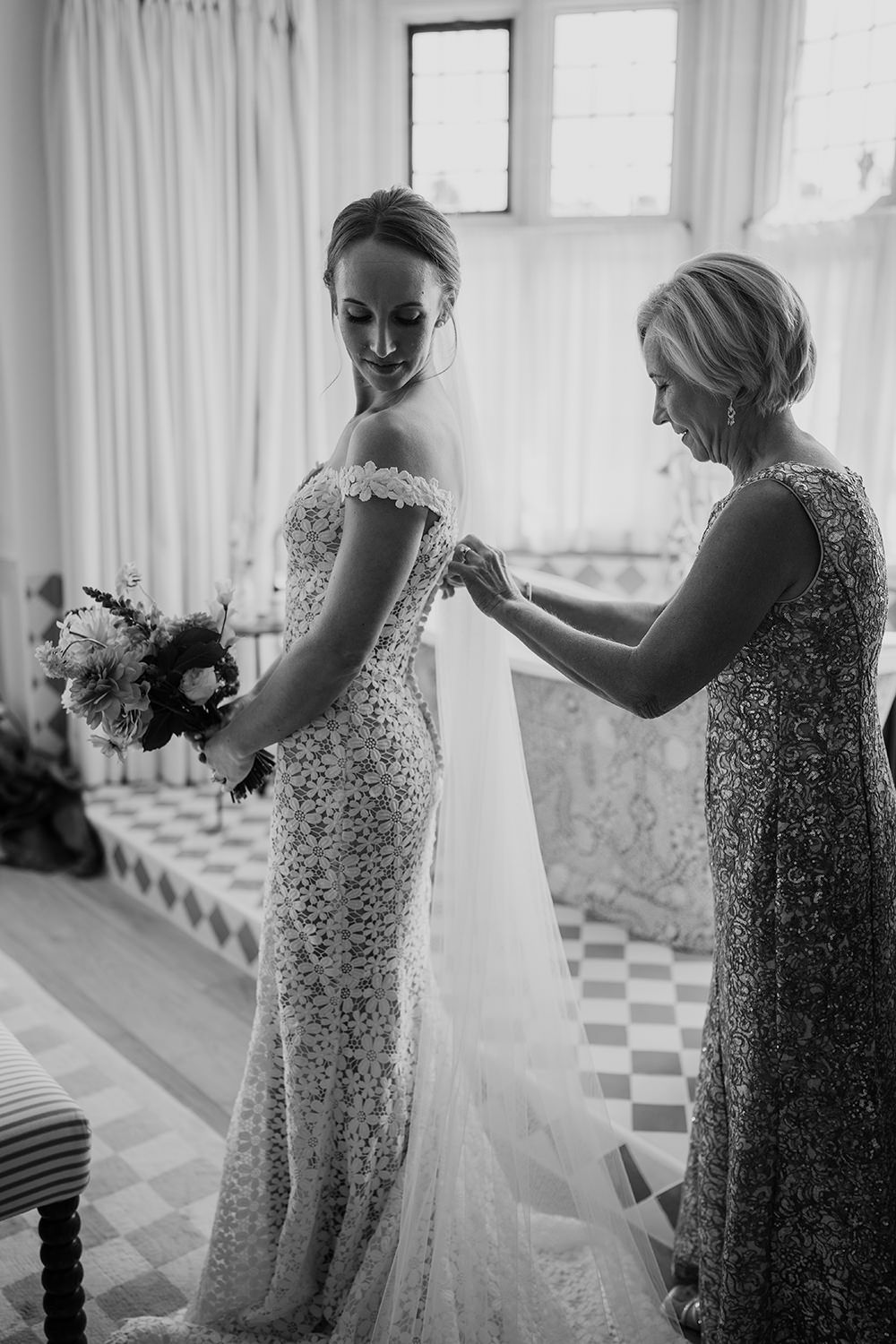 Mother of the bride fastening her daughter in her wedding dress at Kin House.
