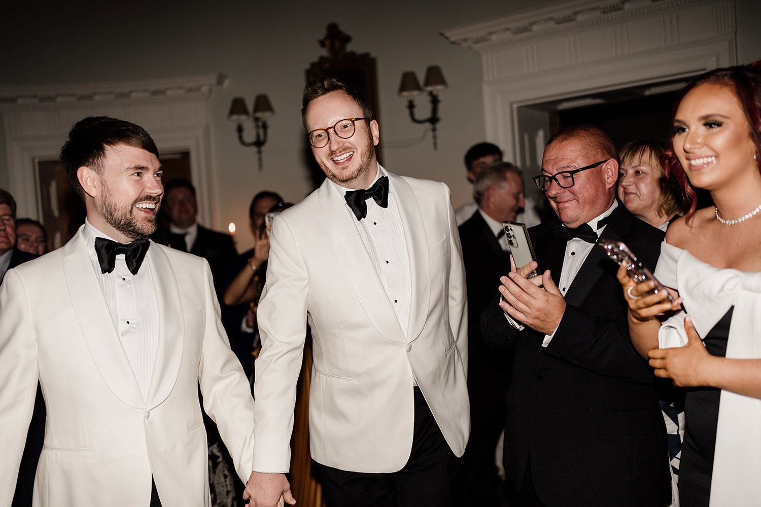 The grooms enter into the evening celebrations at Middleton Lodge Estate.
