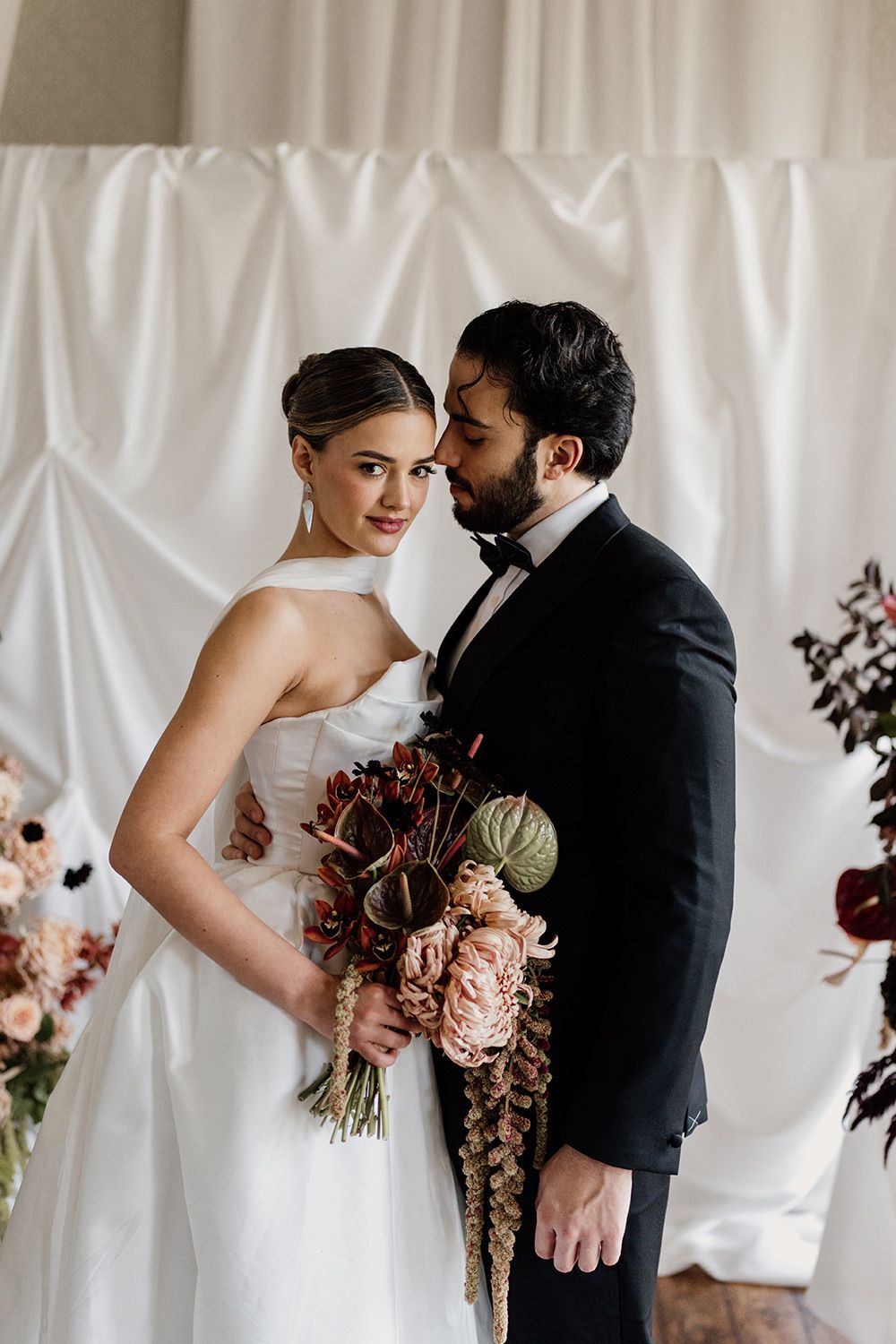 Bride and groom looking towards each other during their wedding ceremony at Rise Hall.