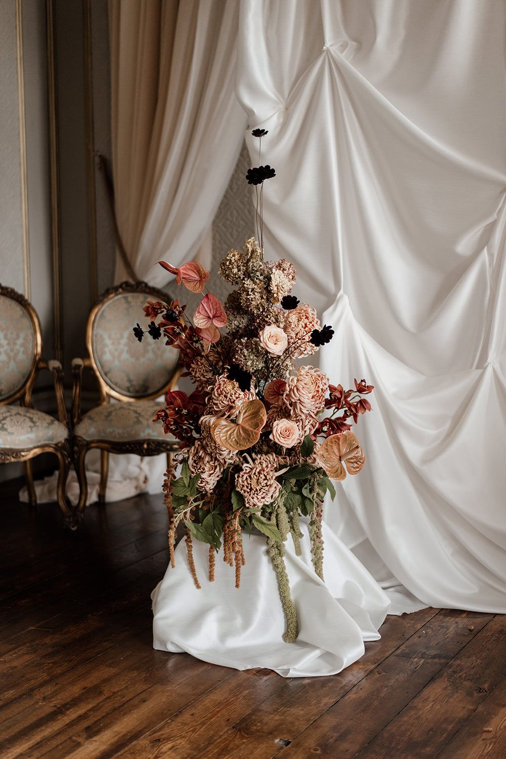 Autumnal wedding flowers with red, burgundy, pink and white flowers.