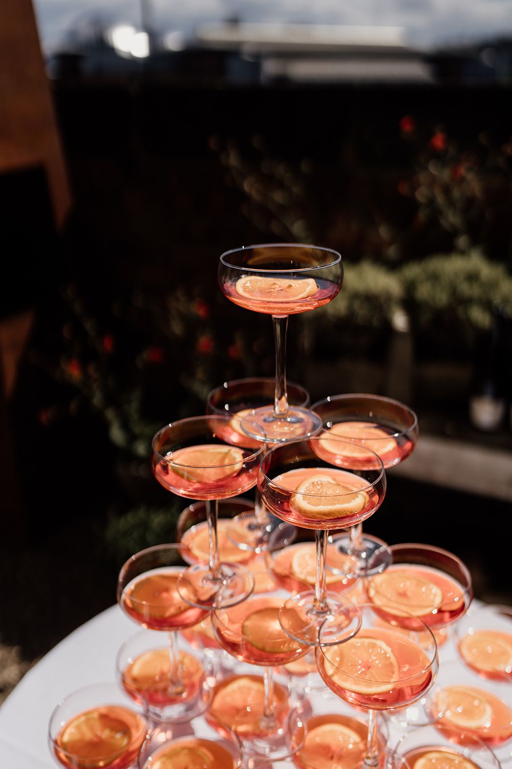 A cool take on a wedding day champagne tower aperol spritz on the rooftop terrace.