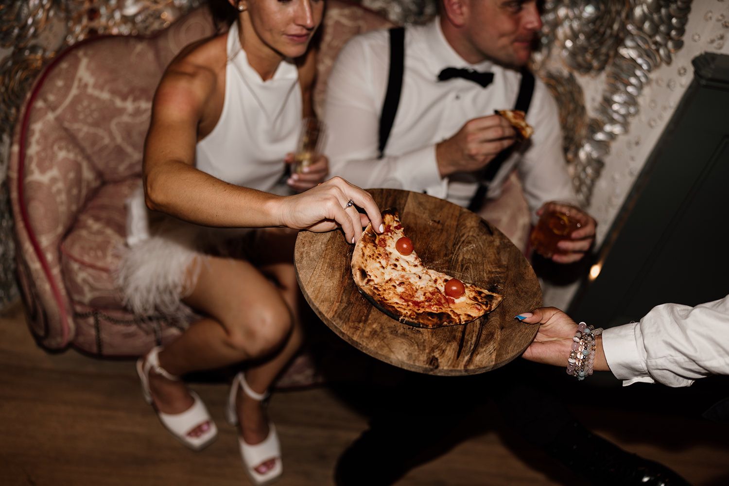 Editorial wedding portraits of bride and groom at Kin House’s iconic shell chair eating pizza.