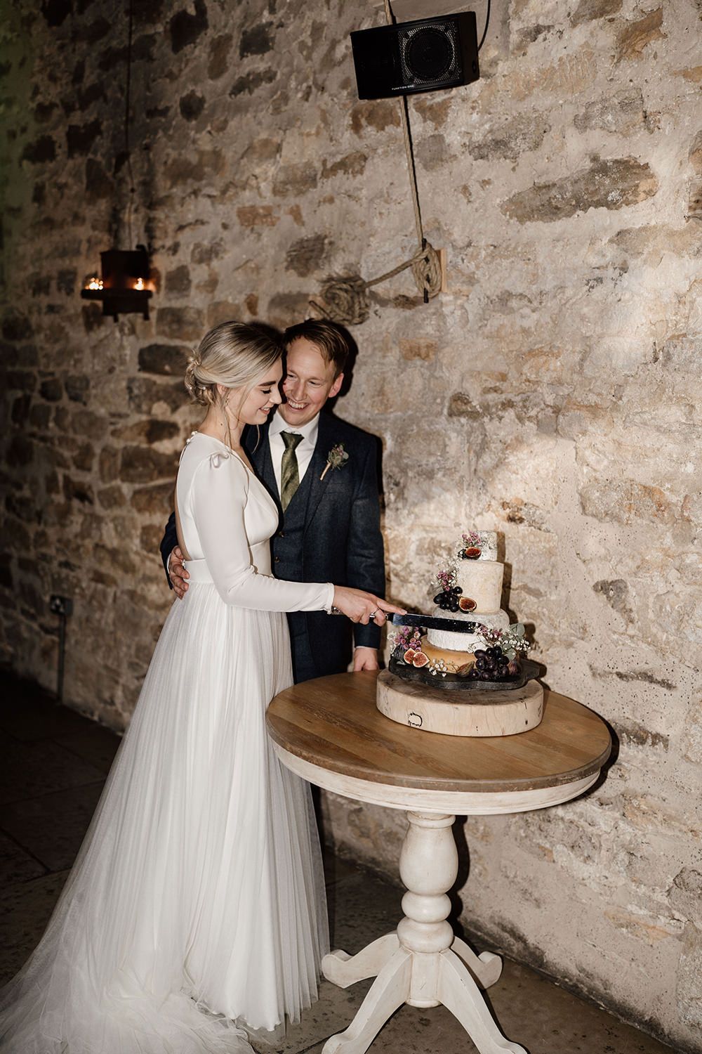 Bride and groom cutting their cheese cake at Healey Barn.