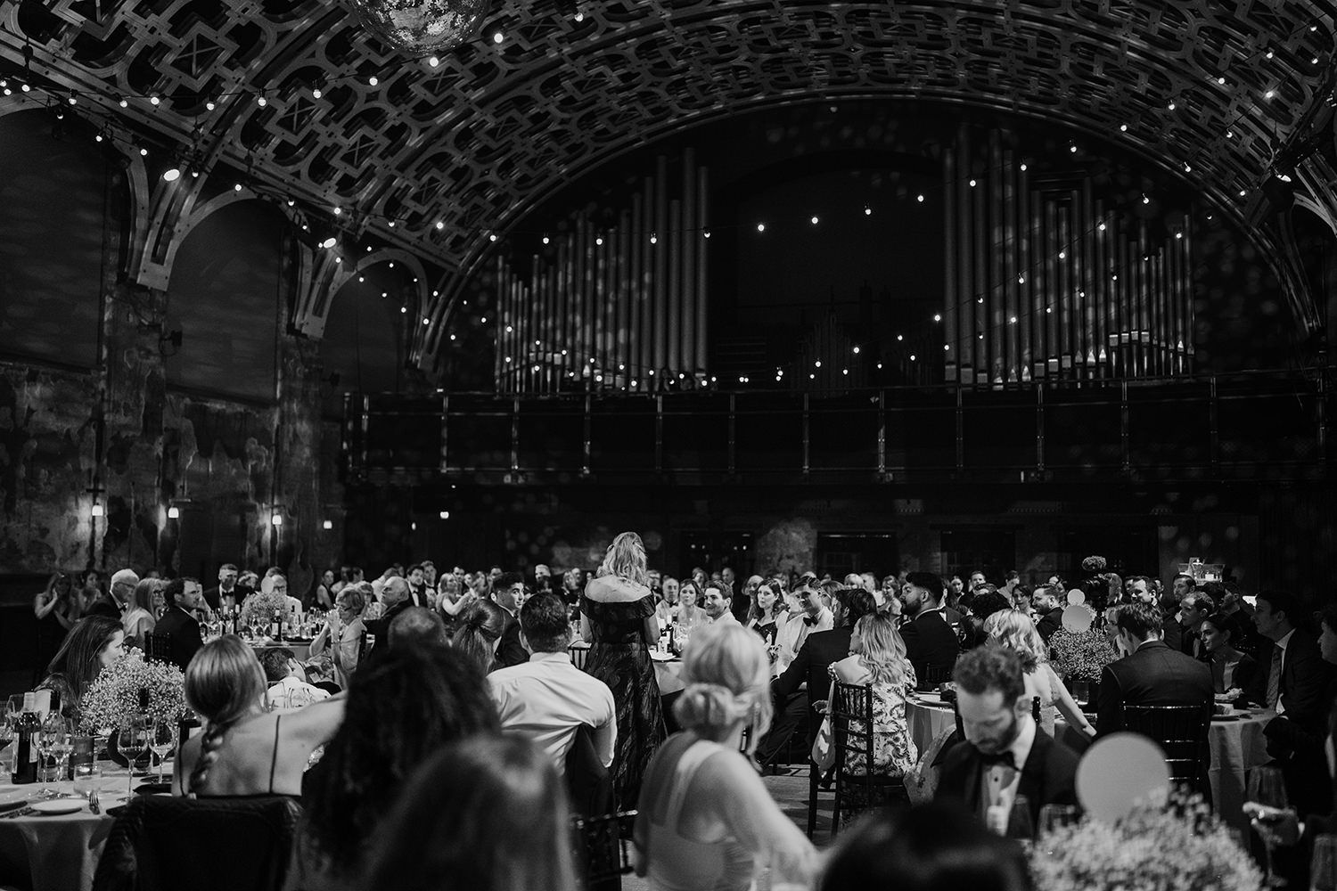 Guests sat listening to wedding speeches at Battersea Arts Centre.