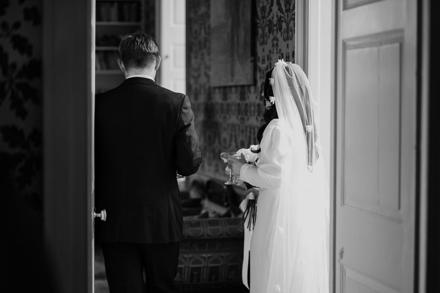 Bride and groom holding champagne after their wedding ceremony.