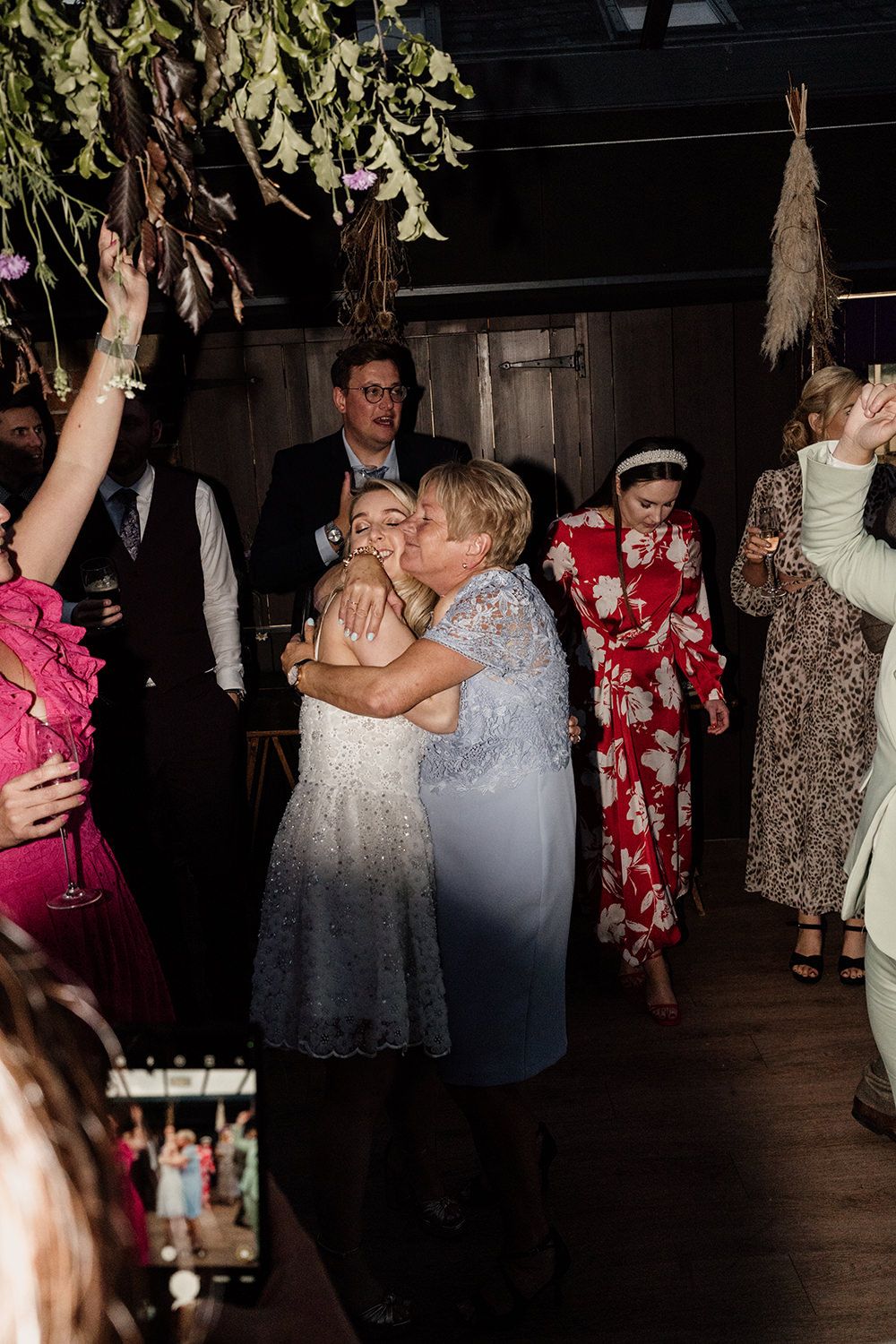 Bride and her mam hugging after the wedding first dance at kin house.