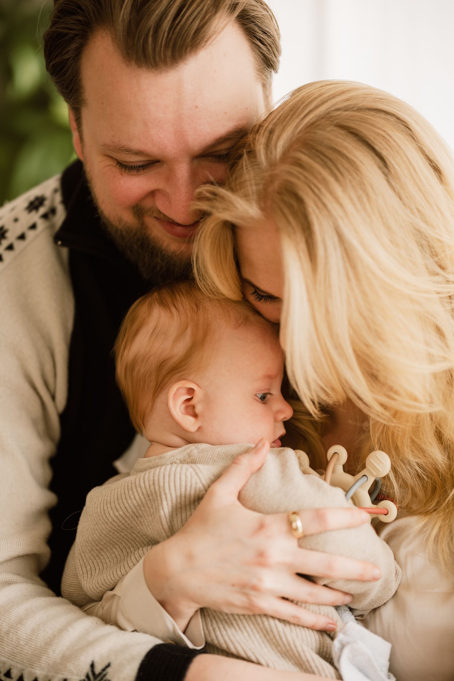 An intimate family portrait showing tender moments of closeness and affection in natural lighting.
