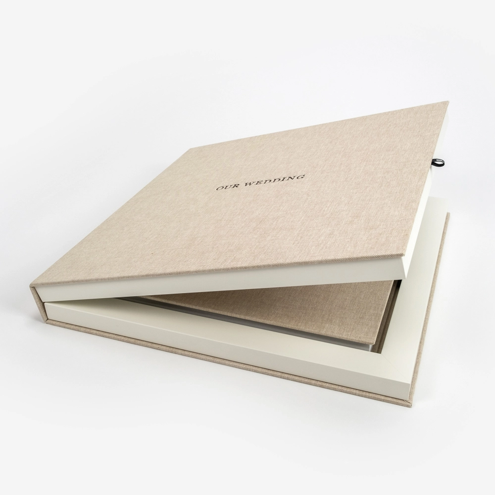 Elegant linen-covered wedding photo album with matching keepsake box in neutral beige tone.