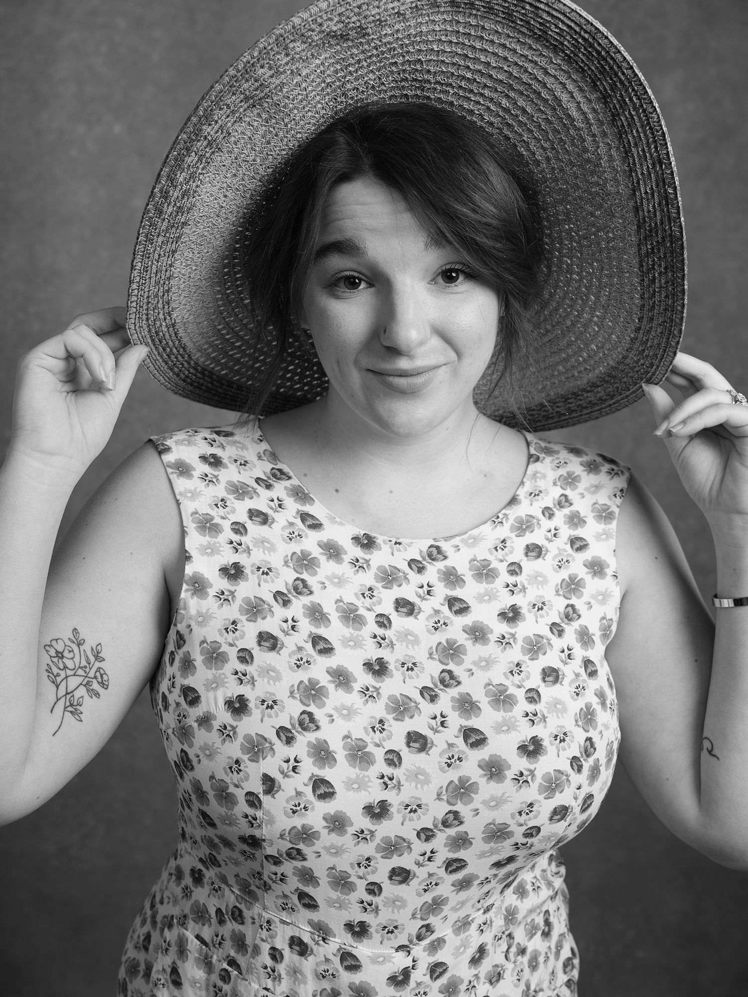 A vintage-style portrait featuring a floaty summer dress and wide-brimmed sunhat.