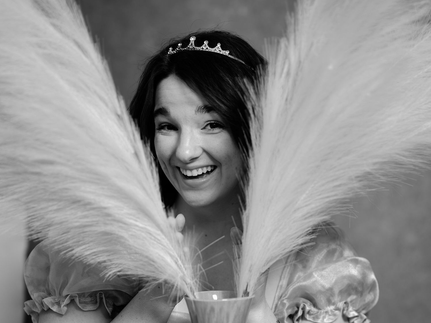A theatrical portrait with dramatic white feathers and a small tiara.