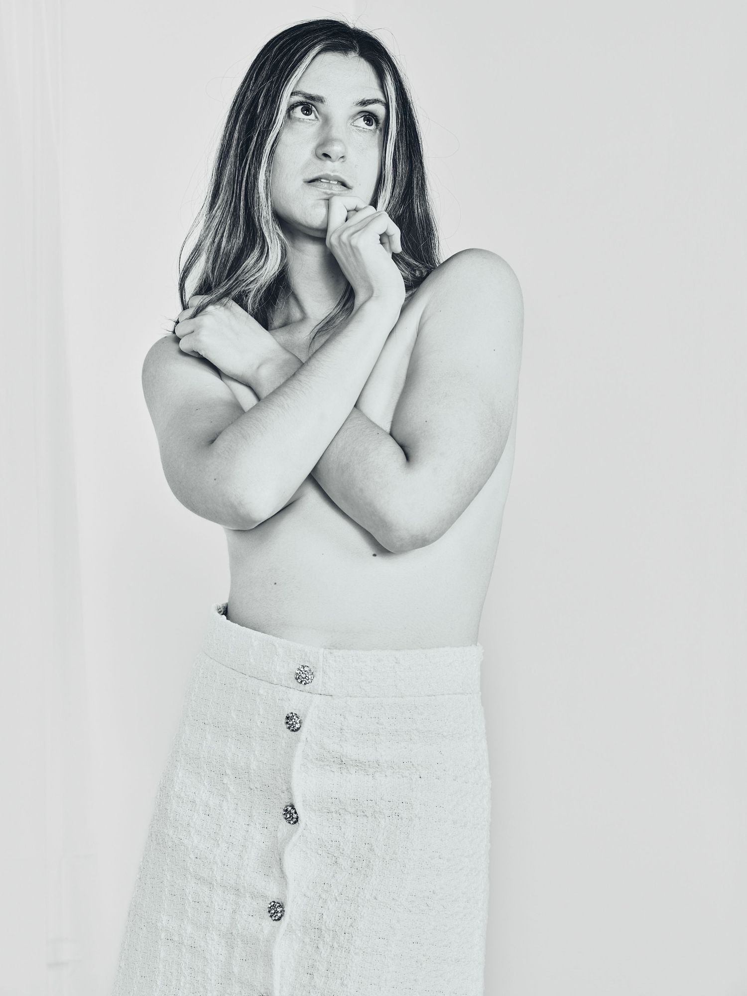 A series of atmospheric fashion poses against a white backdrop showing off a light-colored skirt.