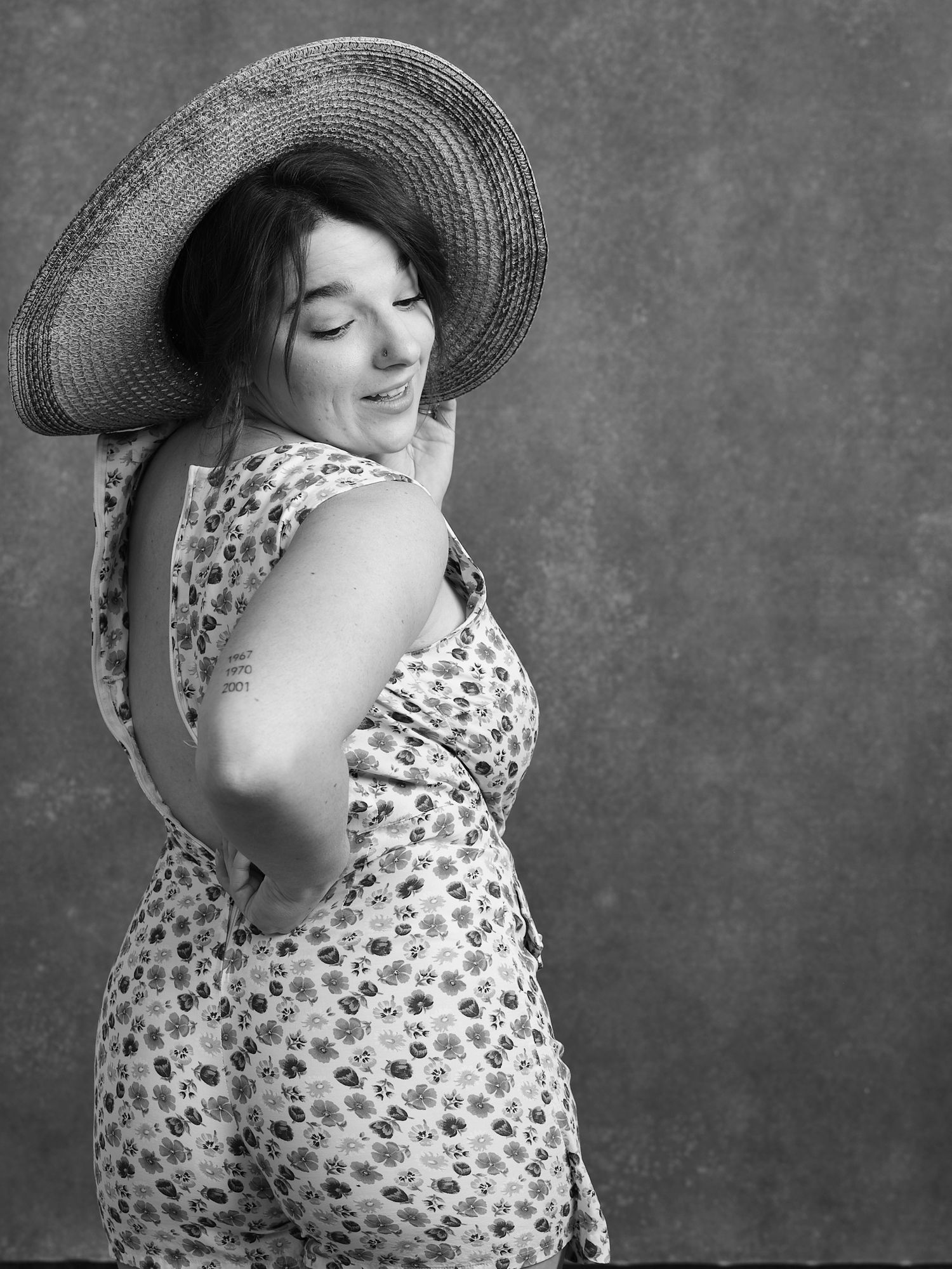 A retro-inspired portrait pose in a polka dot dress and wide-brimmed hat.