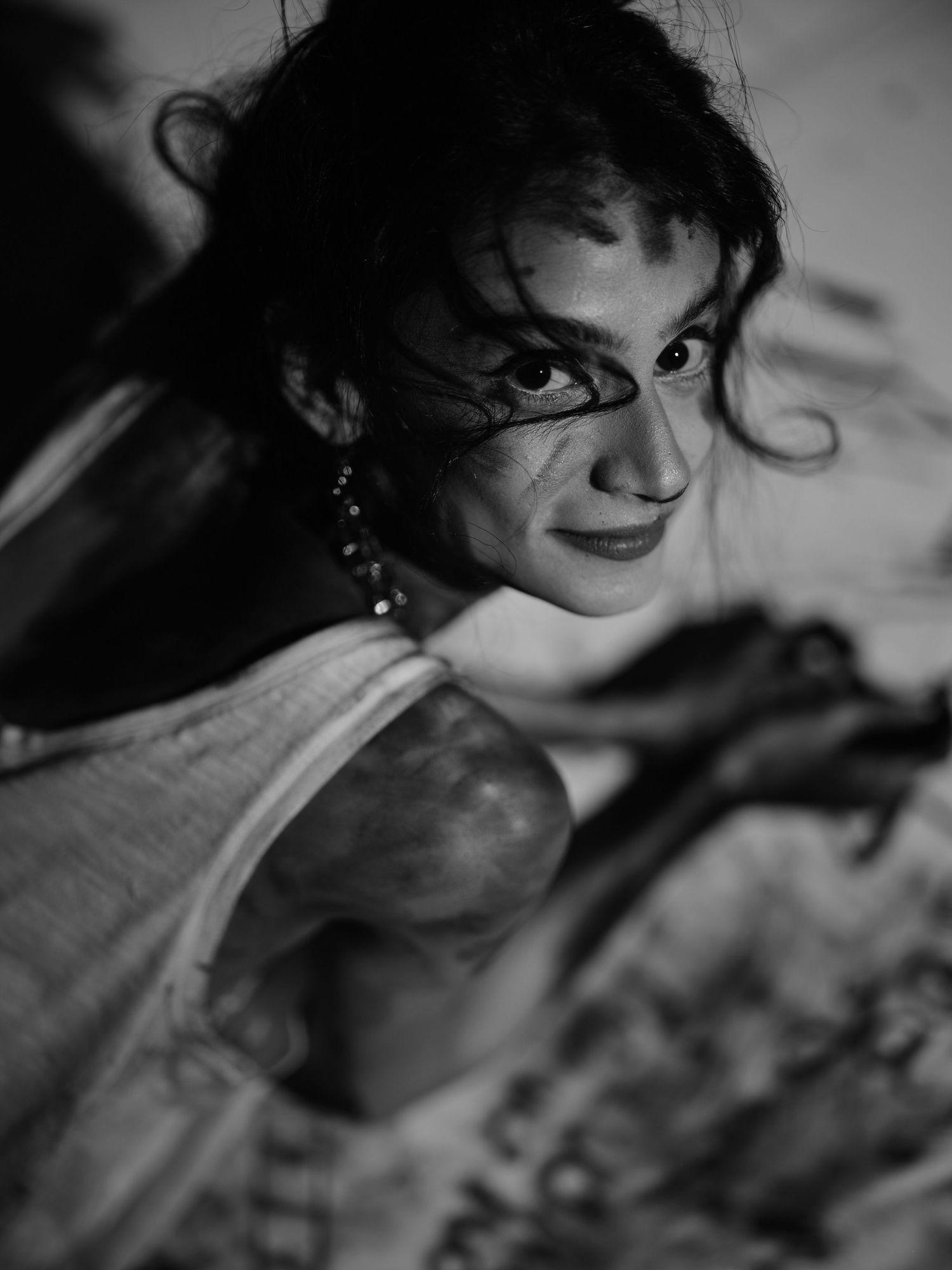 Dramatic black and white portrait with artistic lighting and charcoal elements.