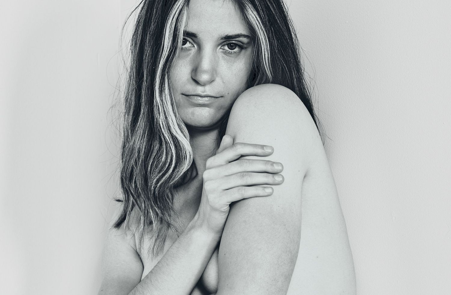 Artistic black and white portrait, Genevieve in vulnerable pose.