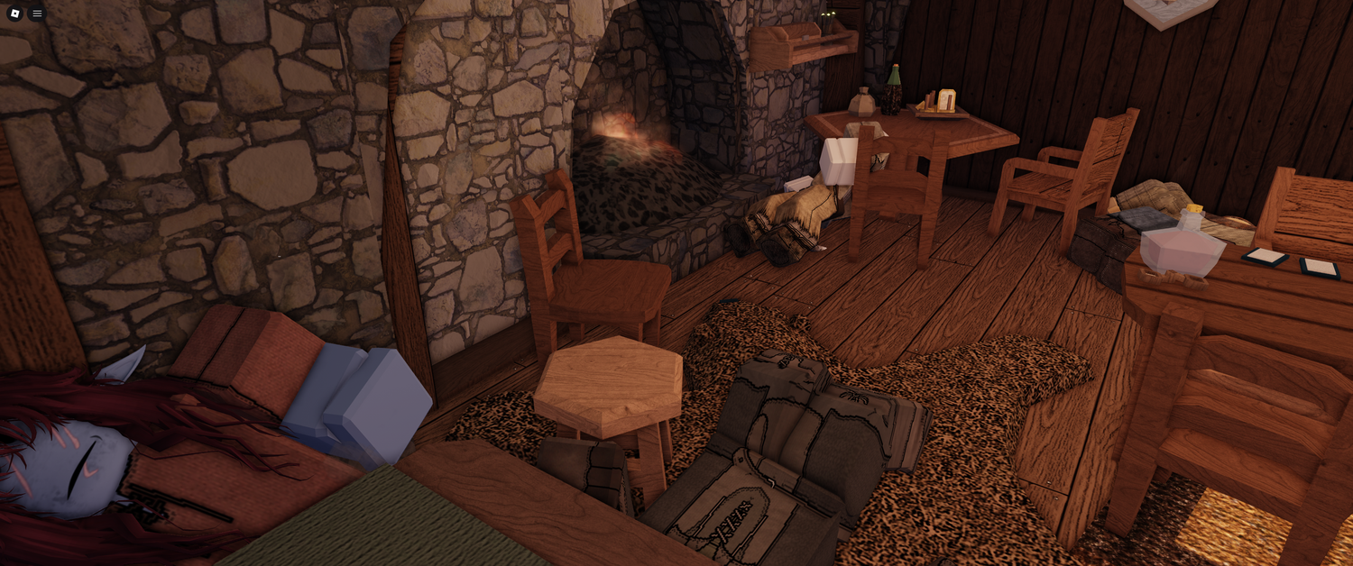 Medieval tavern interior with stone walls, wooden furniture and scattered items.