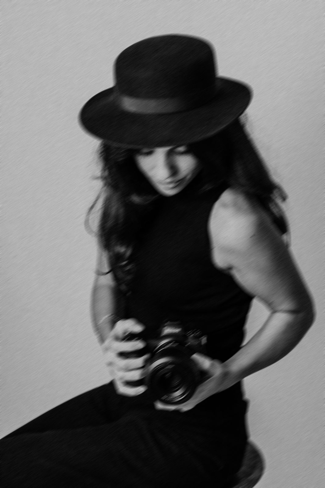 Artistic black and white portrait series of a figure in a wide-brimmed hat creating dramatic shadows.