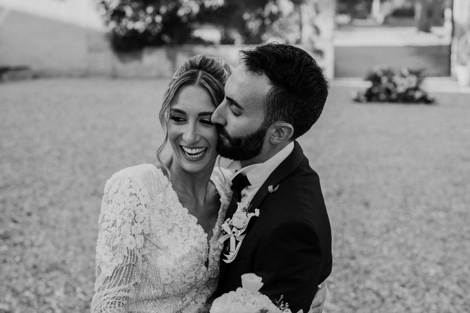 Black and white wedding photos showing intimate moments between newlyweds in an outdoor garden setting.