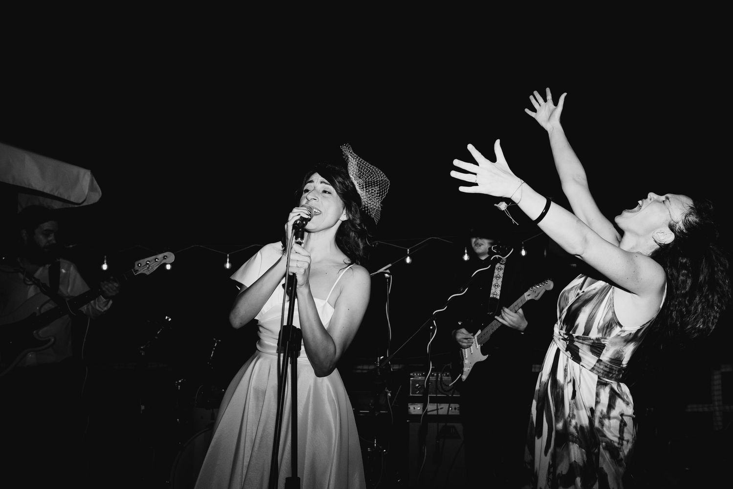 A series of black and white concert photos showing a performer singing into a microphone on stage.