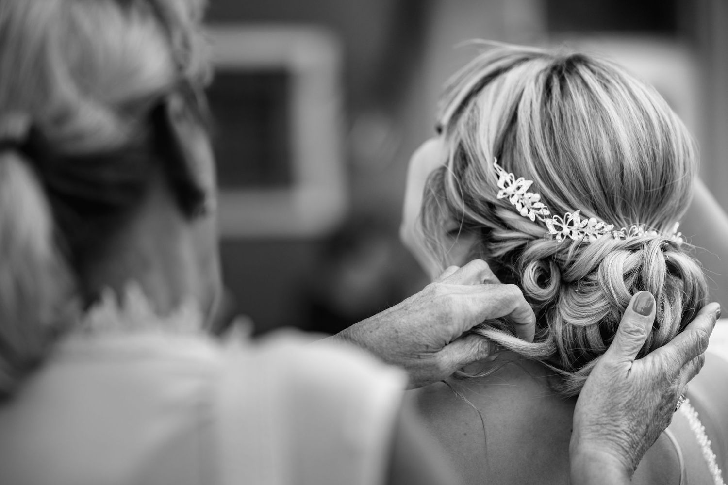 Black and white close-up shots of bridal hair accessories and styling details.