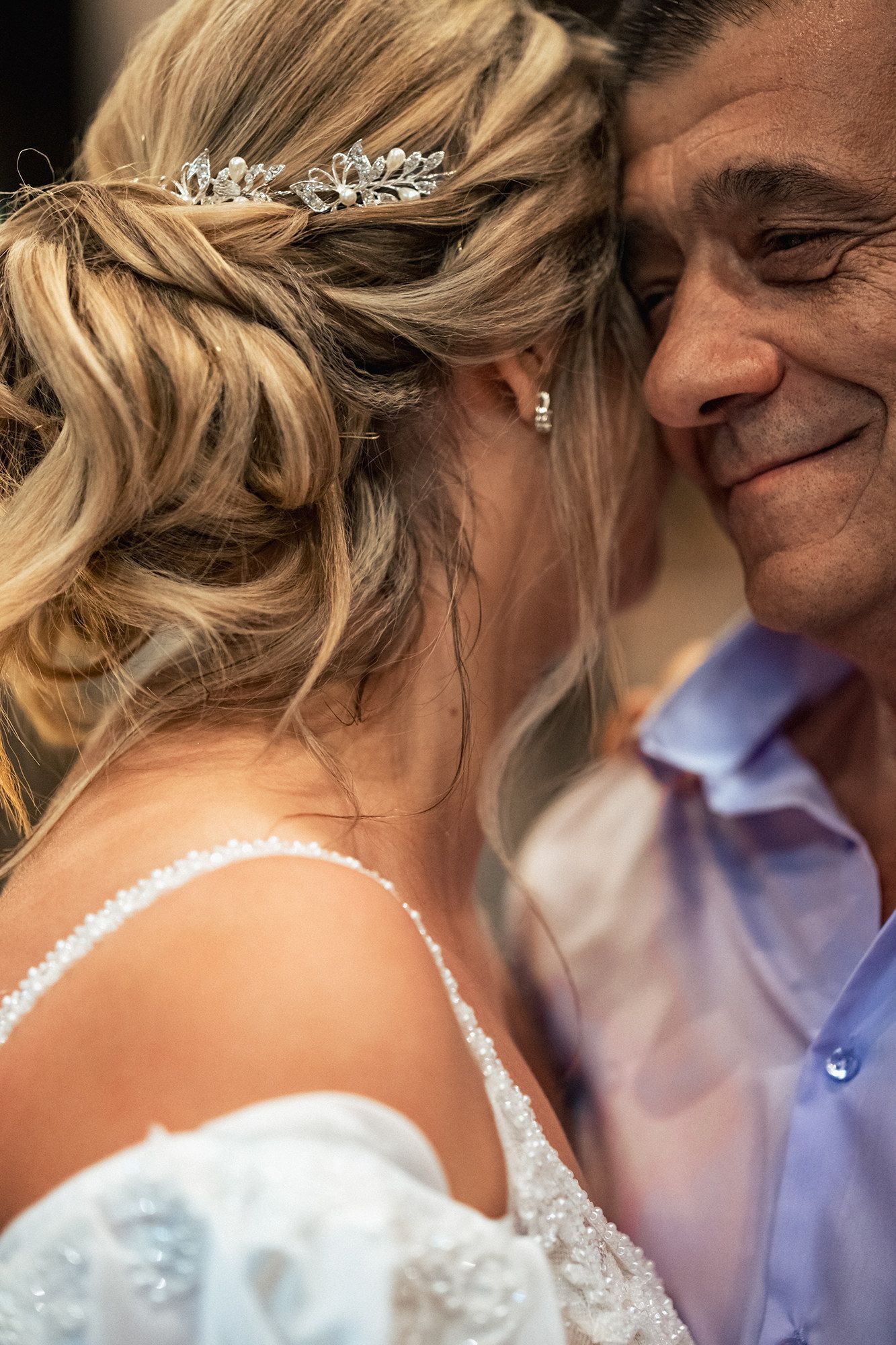 Intimate close-up of a bride and groom sharing a tender moment during their wedding celebration.