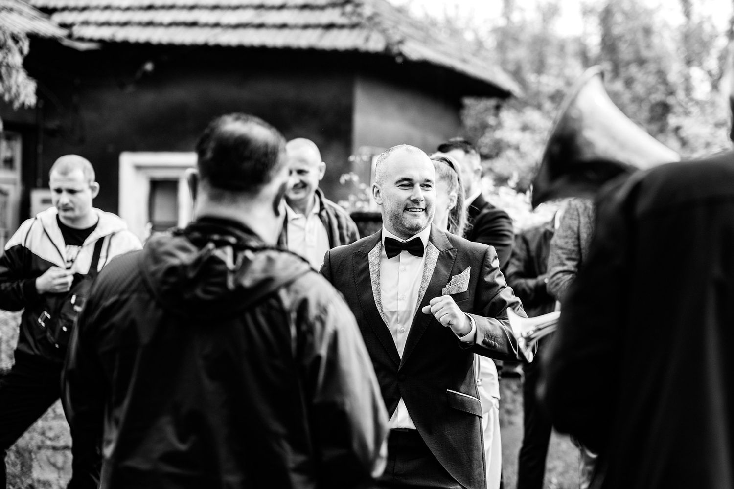 Black and white candid shots of wedding guests during outdoor ceremony.