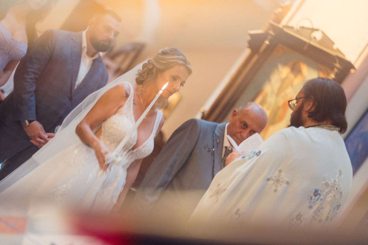 Wedding celebration during golden hour with guests gathered outdoors.